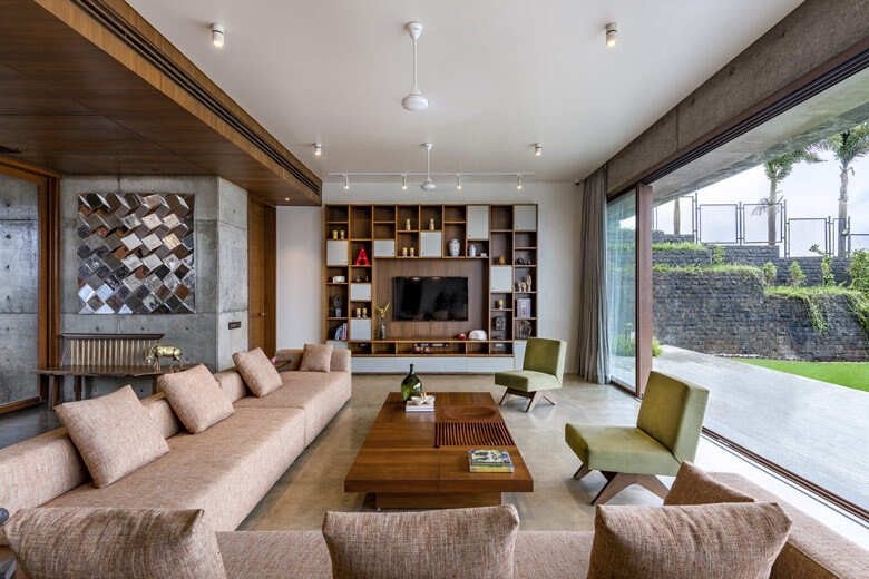 Living room opening onto a garden through full-height glass
